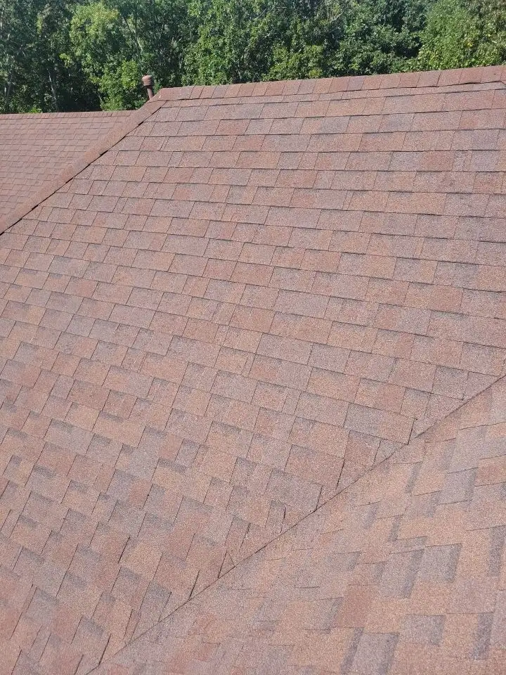 A roof with a brown shingle, showing the underside of the roof.